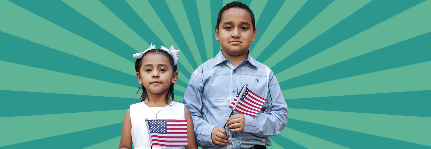 A young boy and girl hold American flags.