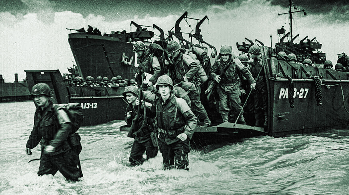 Soldiers disembark from an amphibious landing craft.