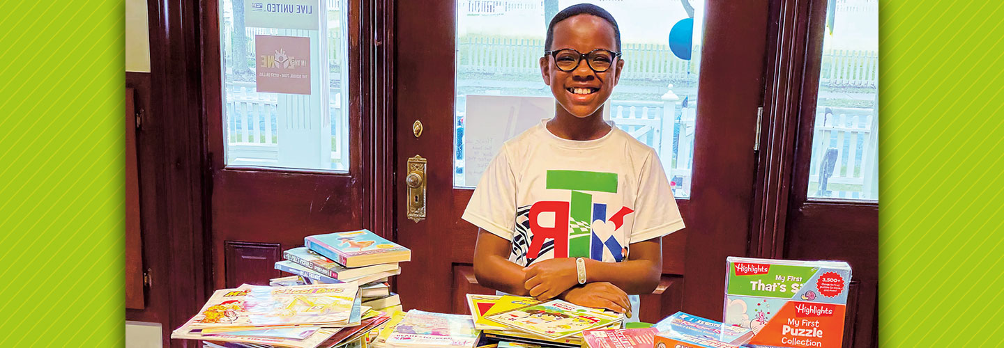 Student in front of his book donations