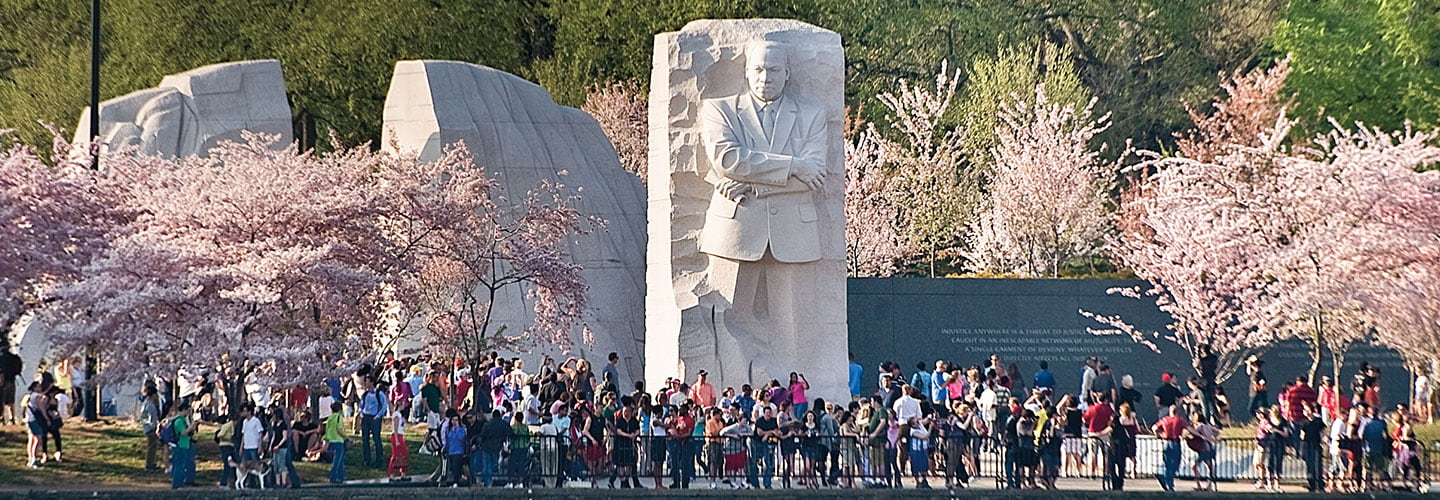 MLK Jr memorial with many tourists standing in front of it