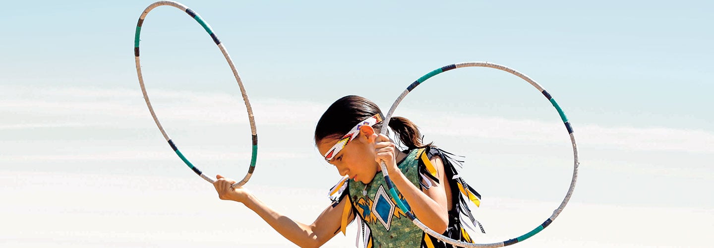 Hoop dancer wearing traditional native dancing clothes