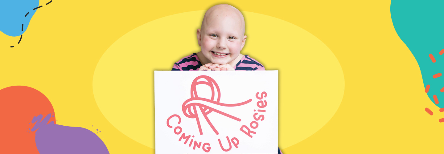 Image of a child smiling while holding a sign that reads, "Coming Up Rosies"
