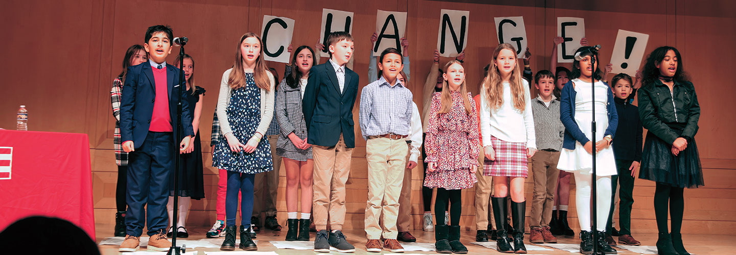 Image of students performing on stage with the word, "Change!" in the background