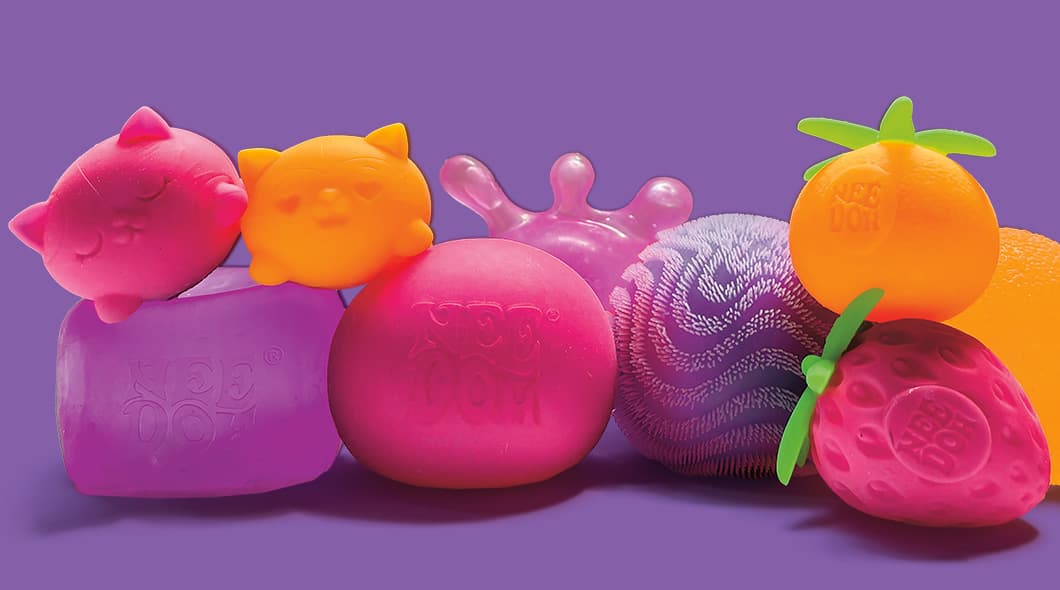A collection of colorful Yee Doh branded squishy toys in animal and fruit shapes
