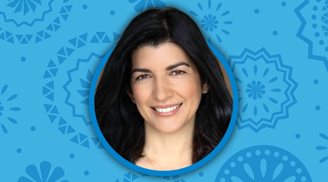 A portrait of a woman with dark hair set against a blue patterned background