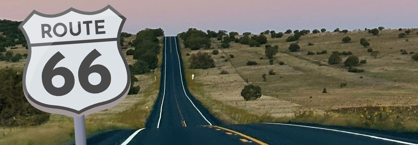 Composite image of a shield sign reading Route 66 beside an empty two-lane highway crossing dry hills